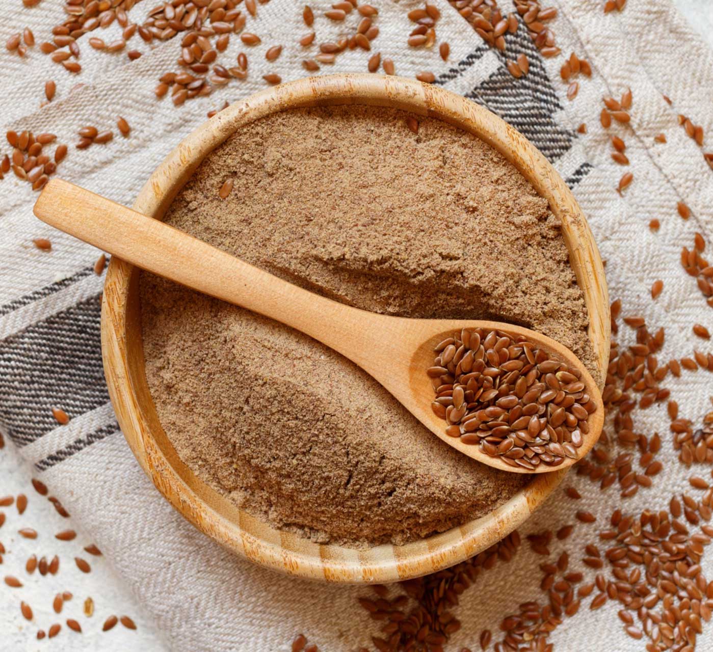 raw flaxseed flour in wooden bowl
