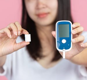 woman glocumeter diabetes sugar cube